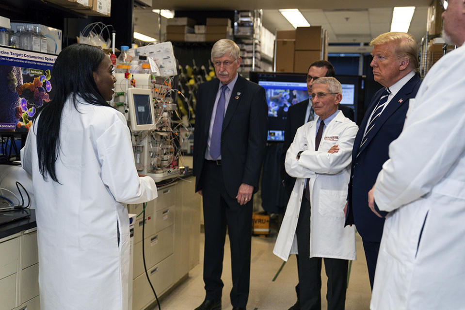 President Donald Trump tours the Viral Pathogenesis Laboratory at the National Institutes of Health in March. Dozens of research groups around the world are racing to create a vaccine as Covid-19 cases continue to grow.