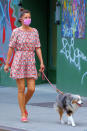 <p>Model Helena Christensen wears a cute summer dress and a lavender mask as she walks her dog in N.Y.C.'s West Village neighborhood on Thursday.</p>