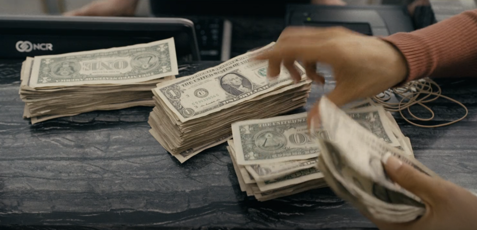 Jennifer Lopez's character counting her money from working in "Hustlers"