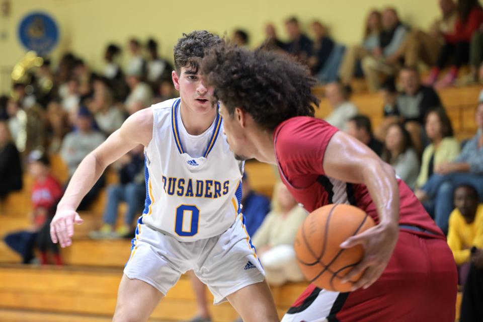 Cardinal Newman shooting guard Alex Grande (0) stares down a Saint Andrews player to determine his next move during a game on Jan. 30, 2024.