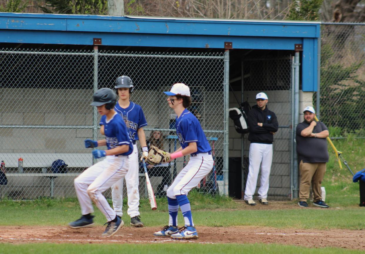 Varsity coach Nick Taylor and middle school coach Jeremy LaPointe look on at a play at the plate during Murdock's game on May 1, 2024.