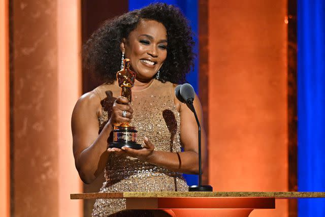 <p>ROBYN BECK/AFP via Getty</p> Angela Bassett accepting her Academy Honorary Award