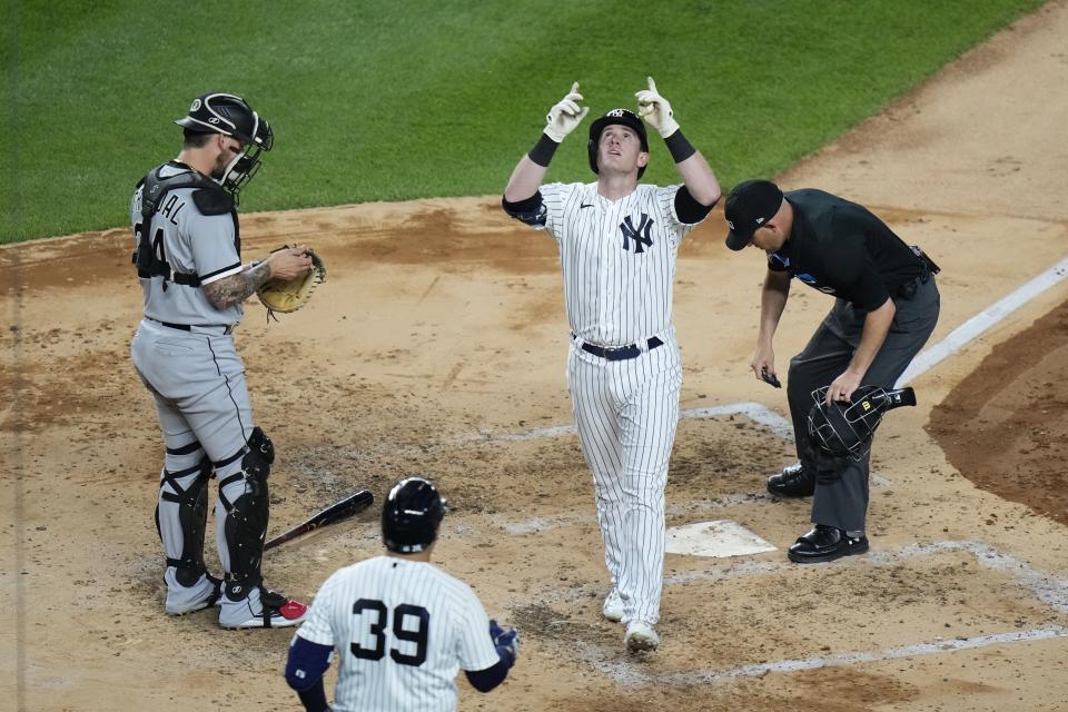 Chicago White Sox catcher Yasmani Grandal, left, looks on as New York Yankees' Billy McKinney, second from right, reaches home plate after hitting a home run during the fifth inning in the second baseball game of a doubleheader Thursday, June 8, 2023, in New York. (AP Photo/Frank Franklin II)