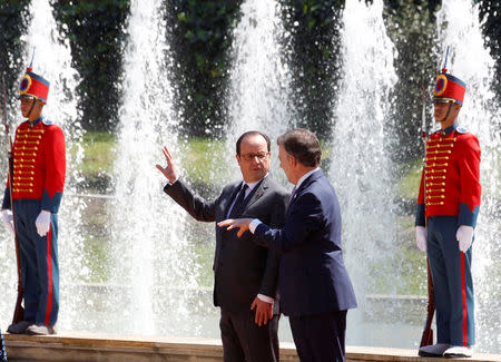 France's President Francois Hollande (L) and his Colombian counterpart Juan Manuel Santos talk during a welcome ceremony for Hollande outside the presidential palace in Bogota, Colombia, January 23, 2017. REUTERS/Inalper Castillo