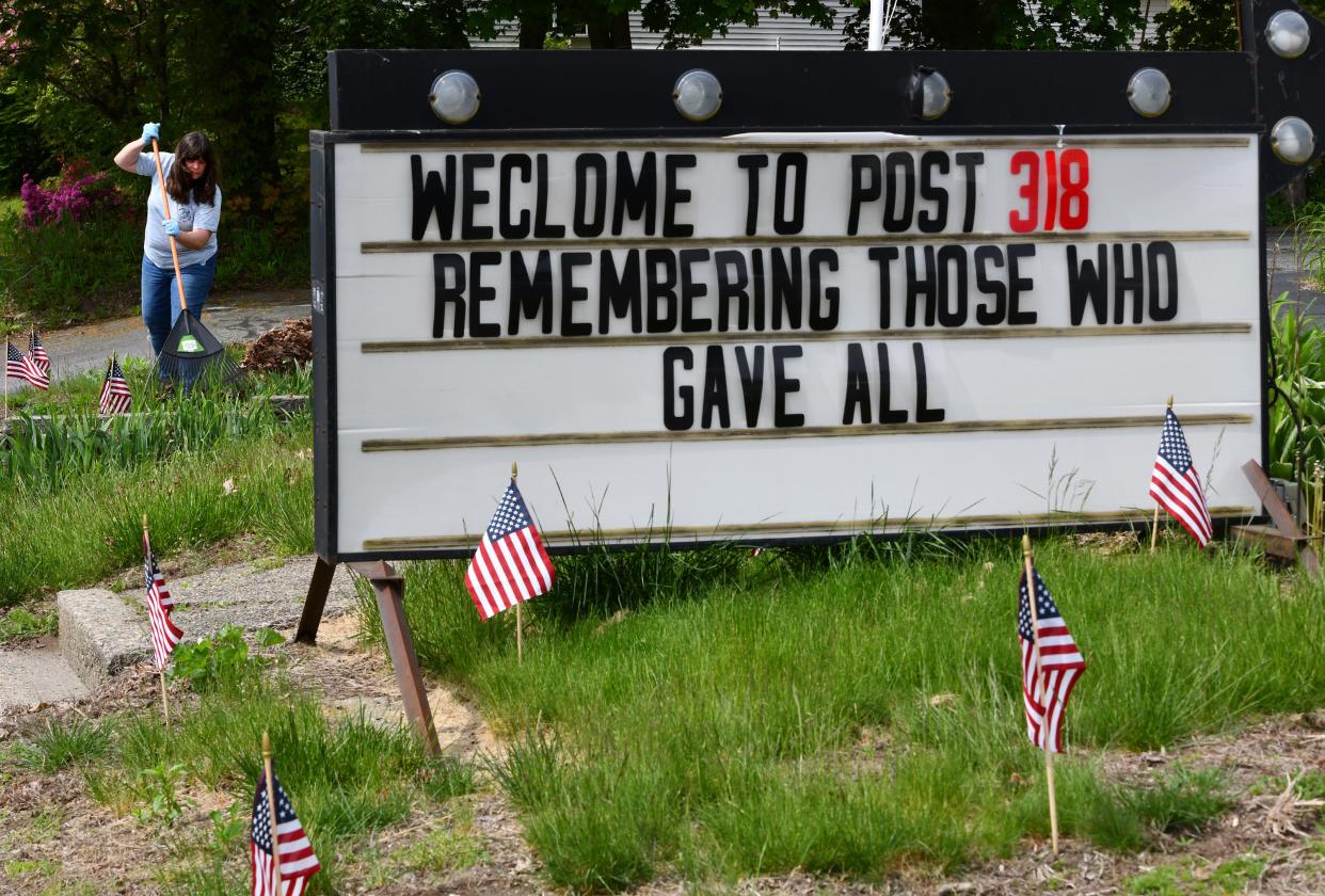 Robin Powers, bar manager at American Legion Qunsigamond Post 318 on Greenwood Street in Worcester, cleans up around the post's memorial Wednesday in preparation for a flag raising ceremony out front at noon Memorial Day.