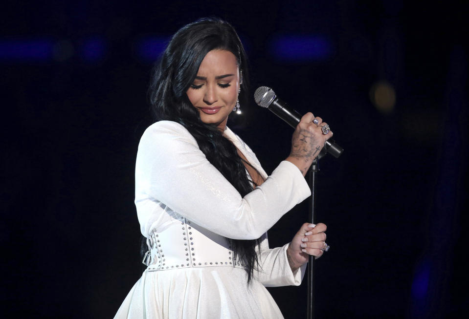 FILE - Demi Lovato performs "Anyone" at the 62nd annual Grammy Awards on Jan. 26, 2020, in Los Angeles. Lovato reveals publicly for the first time details about her near-fatal drug overdose in 2018 in “Demi Lovato: Dancing With the Devil,” a four-part docuseries debuting March 23, 2021, on YouTube Originals. (Photo by Matt Sayles/Invision/AP, File)