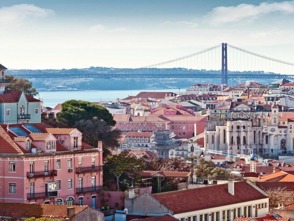 Lisbon, Portugal with buildings, a bridge.