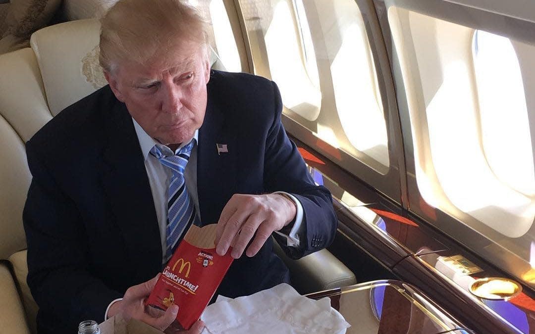 Donald Trump with a McDonald's takeaway on board a private jet