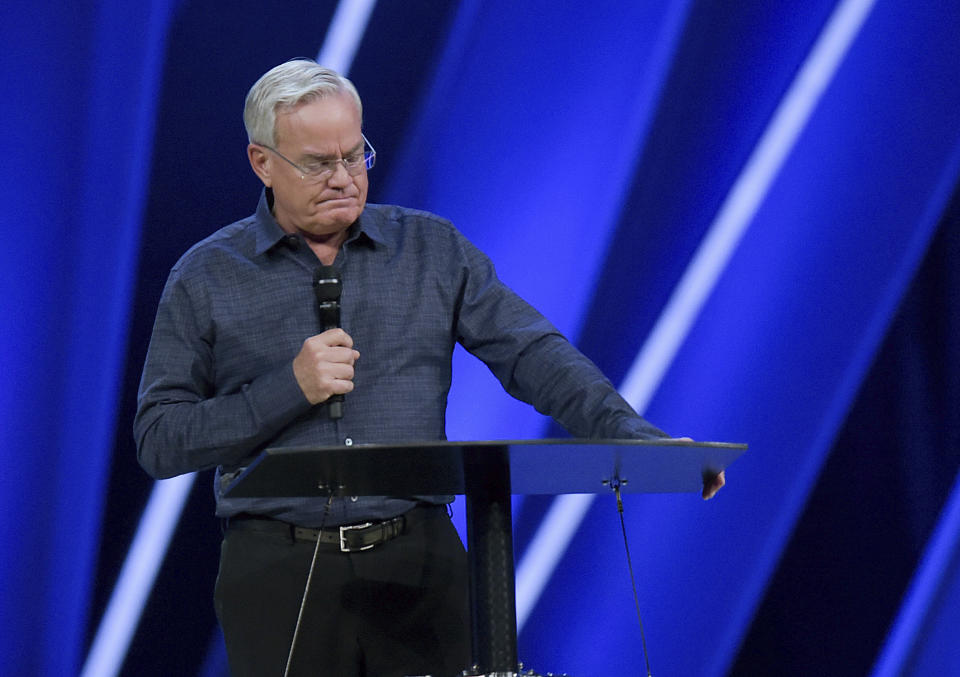 FILE - In this Tuesday, April 10, 2018 file photo, Willow Creek Community Church Senior Pastor Bill Hybels stands before his congregation in South Barrington, Ill., where he announced his early retirement effective immediately, amid a cloud of misconduct allegations involving women in his congregation. The announcement was made during a special meeting at the church, one of the nation's largest evangelical churches, which he founded. (Mark Black/Daily Herald via AP)