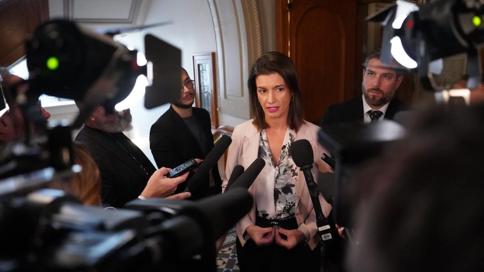 Transport Minister Geneviève Guilbault responds on Oct. 31, 2023 to reporters' questions about the province's negotiations with municipalities concerned about public transit deficits.