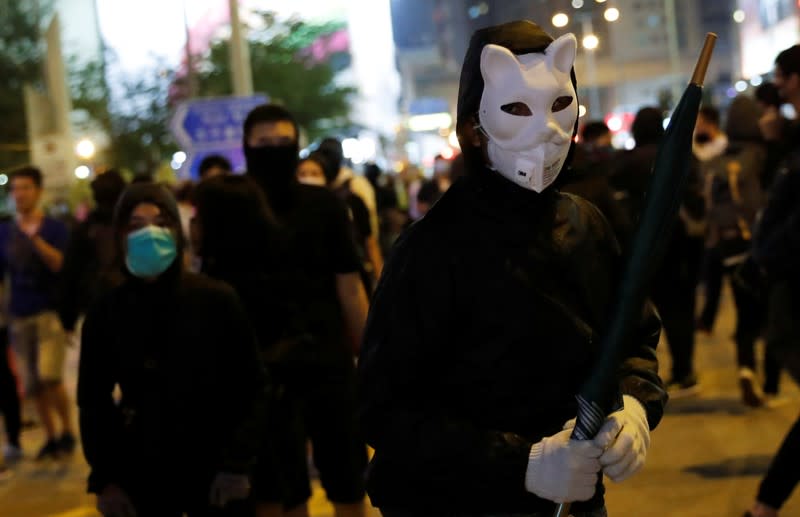 Anti-government protesters wearing costumes march during Halloween in Hong Kong
