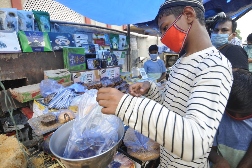 NOIDA, INDIA - JULY 31: People out shopping in the market on the eve of Eid al-Adha at Sector 8 market, on July 31, 2020 in Noida, India. The holy festival of sacrifice, which falls on the 10th day of Dhu al-Hijjah as per the Islamic lunar calendar, is being celebrated today. Bakra Eid or Bakrid is marked by sacrificing an animal that is close to them to prove their devotion and love for Allah. Post the sacrifice, devotees distribute the offering to family, friends, neighbours and especially to the poor and the needy. (Photo by Sunil Ghosh/Hindustan Times via Getty Images)