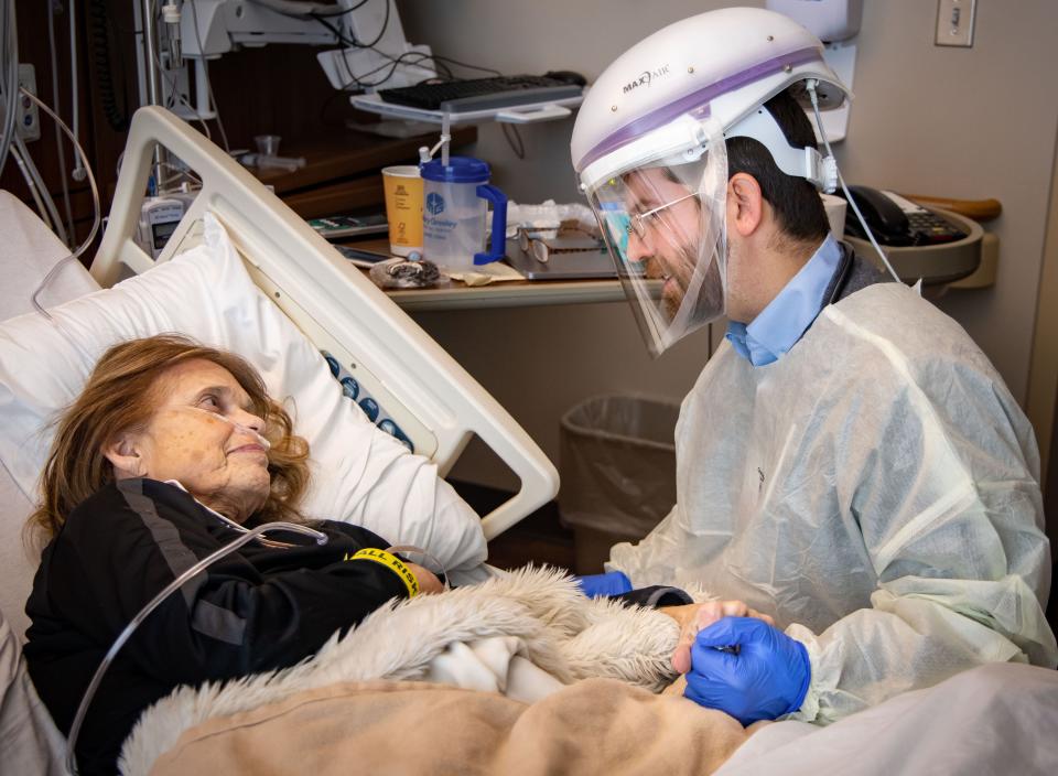 Infectious disease specialist Dr. Dan Fulton visits with COVID-19 patient Barb Gidel.