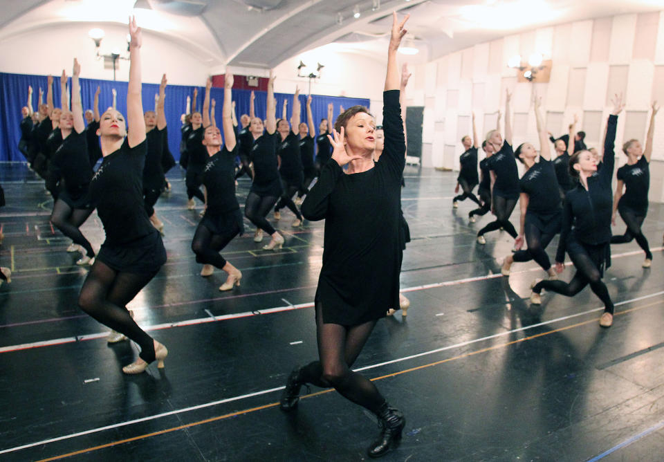 FILE - This Oct. 18, 2012 file image released by Starpix shows Rockettes director and choreographer Linda Haberman, center, with Rockettes dancers during rehearsals for the Radio City Christmas Spectacular at the St. Paul the Apostle Church in New York. The Radio City Christmas Spectacular will celebrate its 85th anniversary of the Rockettes this year. The show opens Nov. 9 through Dec. 30. (AP Photo/Starpix, Dave Allocca)