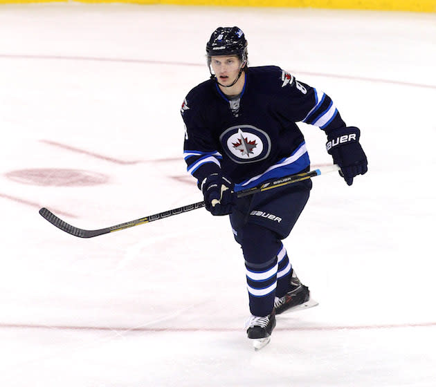 WINNIPEG, MB - OCTOBER 4: Jacob Trouba #8 of the Winnipeg Jets skates down the ice during first period action in an NHL home opener game against the Los Angeles Kings at the MTS Centre on October 4, 2013 in Winnipeg, Manitoba, Canada. (Photo by Marianne Helm/Getty Images)