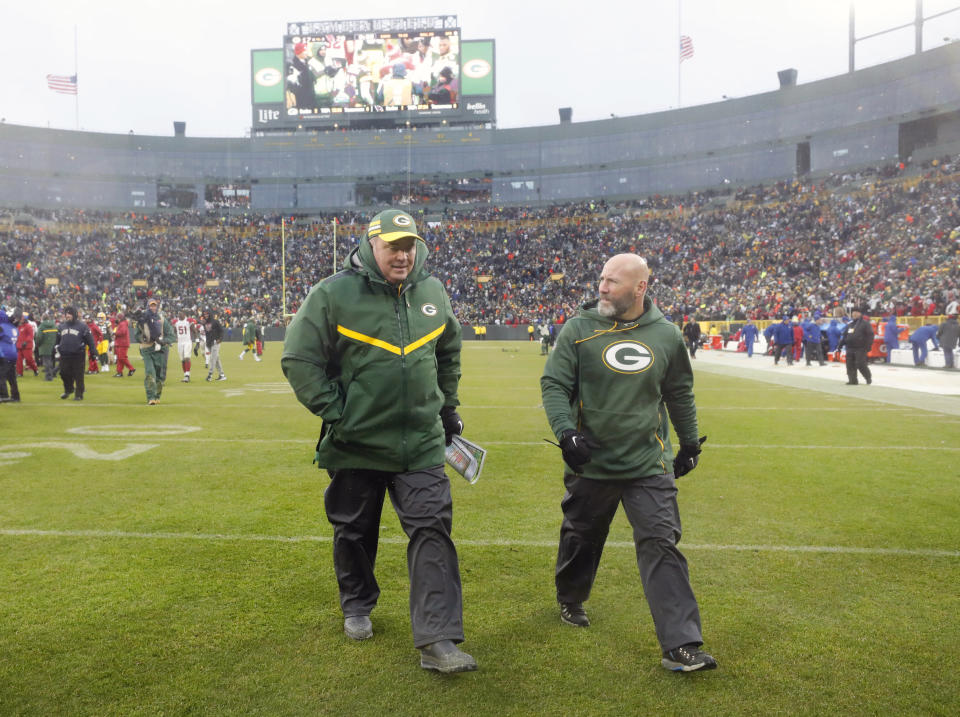 Green Bay Packers head coach Mike McCarthy, left, leaves the field after an NFL football game against the Arizona Cardinals, Sunday, Dec. 2, 2018, in Green Bay, Wis. McCarthy was fired after the game. (AP Photo/Jeffrey Phelps)