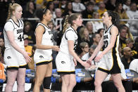Iowa guard Caitlin Clark (22) is greeted by teammates as she comes off the court during the fourth quarter of a Sweet Sixteen round college basketball game against Colorado during the NCAA Tournament, Saturday, March 30, 2024, in Albany, N.Y. (AP Photo/Hans Pennink)