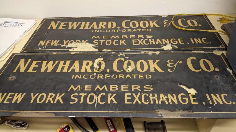 Robert Eckman and Steve Mathews, the new owners of the old Belleville Savings Bank building in downtown Belleville, found old signs for Newhard, Cook & Co. when they started clearing out an old office. The brokerage firm operated at 20 E. Main St. from 1963 to 1992. Jennifer Green/jgreen@bnd.com