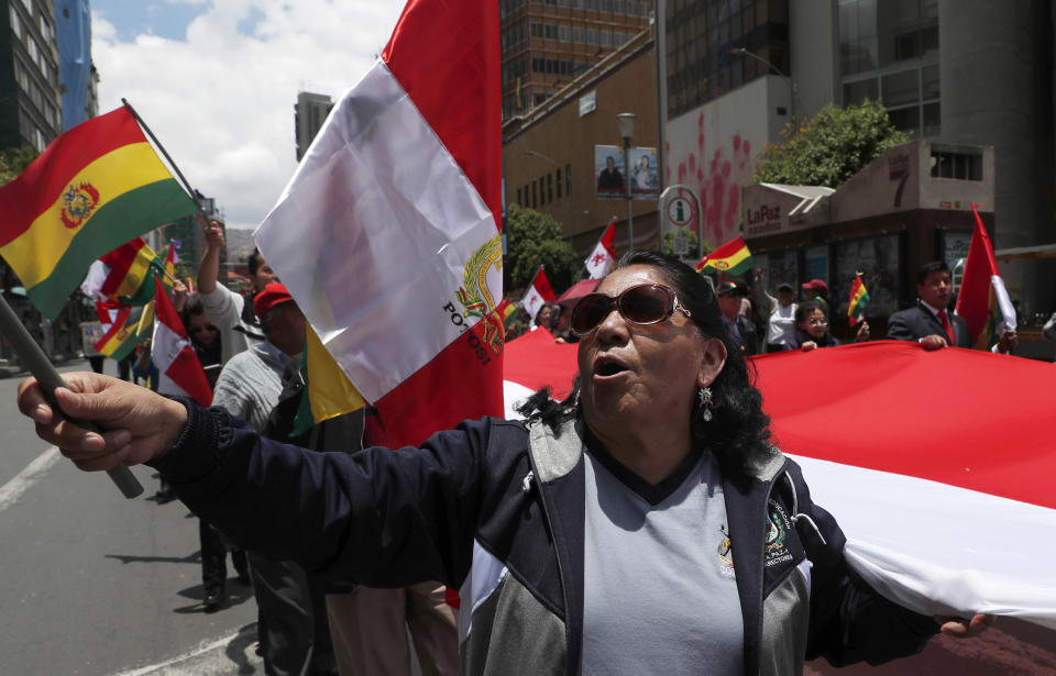 Anti-government protesters march against the reelection of President Evo Morales in La Paz, Bolivia, Sunday, Nov. 10, 2019. President Morales is calling for new presidential elections and an overhaul of the electoral system Sunday after a preliminary report by the Organization of American States found irregularities in the Oct. 20 elections. (AP Photo/Juan Karita)