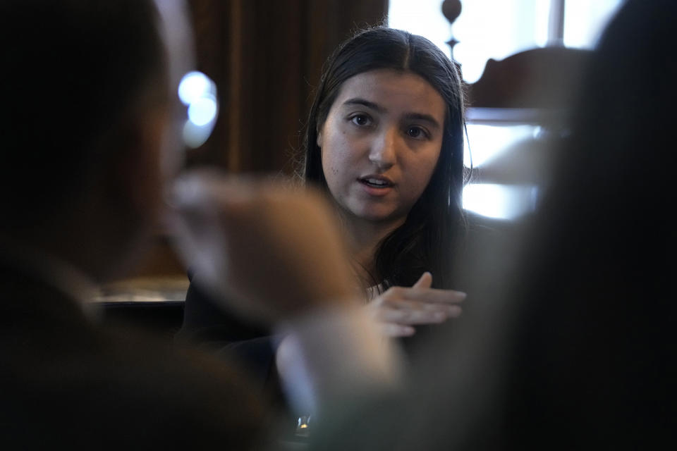 Dartmouth College students Jessica Chiriboga, of Glendora, Calif., and president of the Dartmouth College political union, center, speaks with U.S. Education Secretary Miguel Cardona, foreground left, during in a roundtable discussion, Wednesday, Jan. 10, 2024, on the school's campus, in Hanover, N.H. Fallout from the Israel-Hamas war has roiled campuses across the U.S. and reignited a debate over free speech. (AP Photo/Steven Senne)