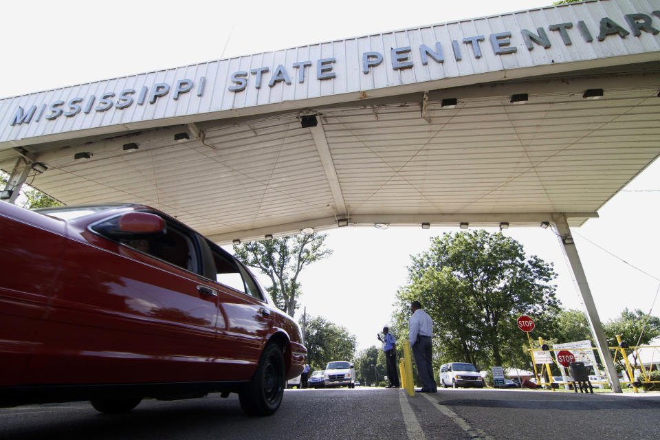 FILE - In this July 21, 2010, photo, employees leave the front gate of the Mississippi State Penitentiary in Parchman, Miss. An inmate at the Mississippi prison that was a focus of recent deadly unrest was found hanging in his cell by two corrections officers over the weekend and pronounced dead, a coroner said Sunday, Jan. 19, 2020. (AP Photo/Rogelio V. Solis, File)