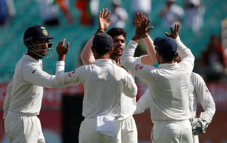 Cricket - India v Australia - Fourth Test cricket match - Himachal Pradesh Cricket Association Stadium, Dharamsala, India - 25/03/17 - India's Umesh Yadav (C-facing camera) celebrates with his teammates after dismissing Australia's Matt Renshaw. REUTERS/Adnan Abidi