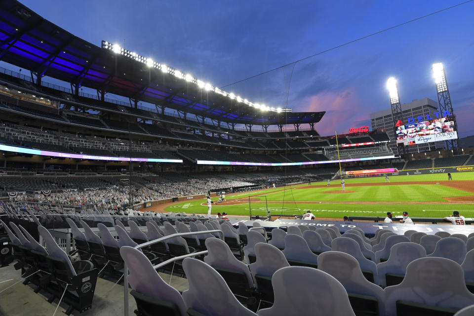 FILE - Cardboard cutouts of fans in the otherwise empty seats face the field during the sixth inning of a baseball game between the Atlanta Braves and Tampa Bay Rays in Atlanta, in this Thursday, July 30, 2020, file photo. Georgia’s new voting law _ which critics claim severely limits access to the ballot box, especially for people of color _ has prompted calls from as high as the White House to consider moving the midsummer classic out of Atlanta. The game is set for July 13 at Truist Park, the Braves’ 41,000-seat stadium in suburban Cobb County.(AP Photo/John Amis, File)