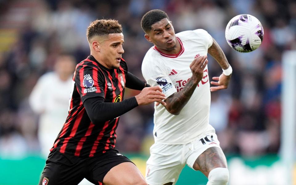 Max Aarons and Marcus Rashford battle for possession.