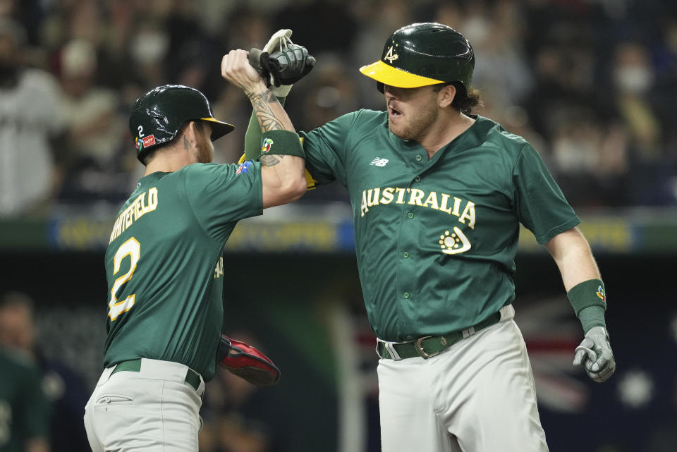 Rixon Wingrove, right, of Australia celebrates with a teammate Aaron Whitefield he makes a home run during the World Baseball Classic quarterfinal game between Cuba and Australia at the Tokyo Dome Tokyo, Wednesday, March 15, 2023. (AP Photo/Toru Hanai)