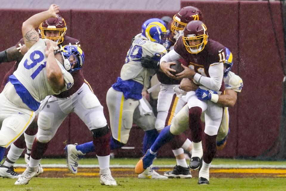 Washington Football Team's Alex Smith is sacked by Los Angeles Rams' Troy Reeder during the second half of an NFL football game Sunday, Oct. 11, 2020, in Landover, Md. (AP Photo/Steve Helber)