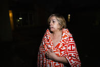 Maria Olivo, a west Houston resident, is shown after a massive explosion blew the window in the room she was sleeping in on Friday, Jan. 24, 2020, in Houston. A massive explosion early Friday leveled a warehouse in Houston and damaged nearby buildings and homes, rousing frightened people from their sleep miles away. (Marie D. De Jesús/Houston Chronicle via AP)