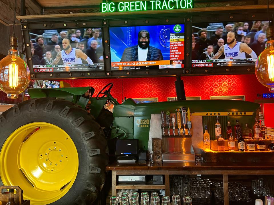 That's a vintage John Deere tractor behind the main bar at Jason Aldean's Kitchen + Bar on Pittsburgh's North Shore.