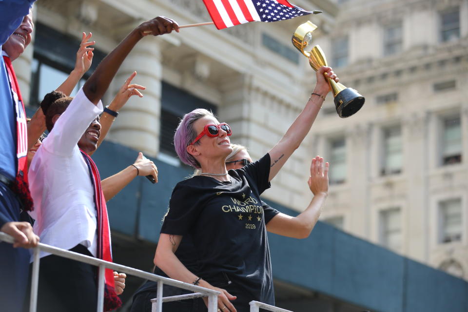 Megan Rapinoe holds the Women's World Cup trophy as the U.S. women's soccer team is celebrated with a parade along the Canyon of Heroes, Wednesday, July 10, 2019, in New York. (Photo: Gordon Donovan/Yahoo News)