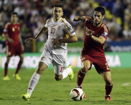 Spain's Isco (R) and Macedonia's Marjan Radeski fight for the ball during their Euro 2016 qualifying soccer match at the Ciudad de Valencia stadium in Valencia, September 8, 2014. REUTERS/Heino Kalis