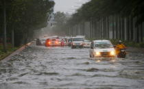 <p>Motorists negotiate a flooded street following heavy rains and strong winds brought about by Typhoon Mangkhut which barreled into northeastern Philippines before dawn Saturday, Sept. 15, 2018 in Manila, Philippines.<br>The typhoon slammed into the Philippines’ northeastern coast early Saturday, its ferocious winds and blinding rain ripping off tin roof sheets and knocking out power, and plowed through the agricultural region at the start of the onslaught.<br>(Photo by Bullit Marquez, AP) </p>