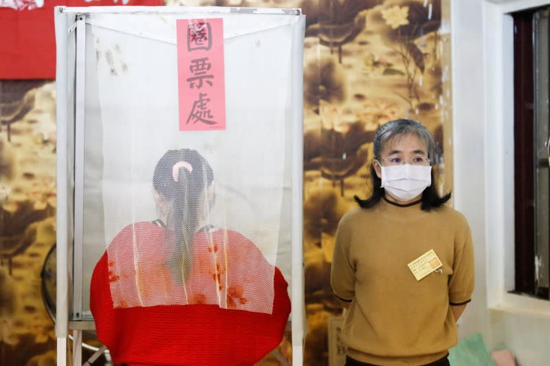 A Taiwanese voter stands at a polling booth during the general elections in Kaohsiung