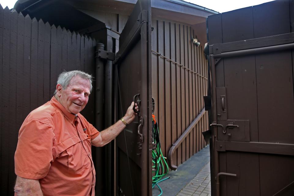 The gate that leads to Bud Wiggins' backyard at his Menomonee Falls home is more than 7 feet tall.