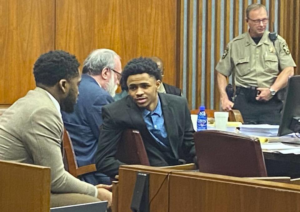 Defendant Jahiem Davis talks with defense attorney Mark Lee.