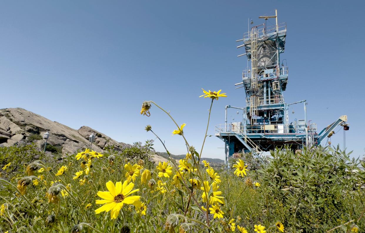 A huge rocket test stand from NASA’s Alfa series towers over the rocky landscape at the Santa Susana Field Laboratory in April. The Los Angeles Regional Water Quality Board wants greater testing of stormwater runoff from the site.