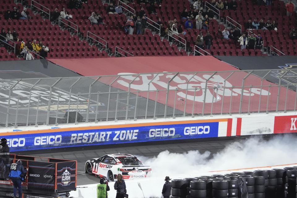 Denny Hamlin (11) bits out after winning the Busch Light Clash NASCAR exhibition auto race at Los Angeles Memorial Coliseum Saturday, Feb. 3, 2024, in Los Angeles. (AP Photo/Mark J. Terrill)