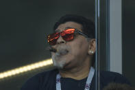 <p>Argentina legend Diego Maradona watches on with a cigar </p>