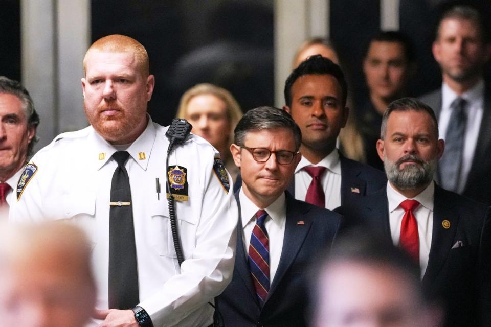 Speaker of the House Mike Johnson, businessman Vivek Ramaswamy and Republican Congressman Cory Mills listen as former President Donald Trump talks with reporters outside Manhattan criminal court on Tuesday (Curtis Means @ 2024/AP)