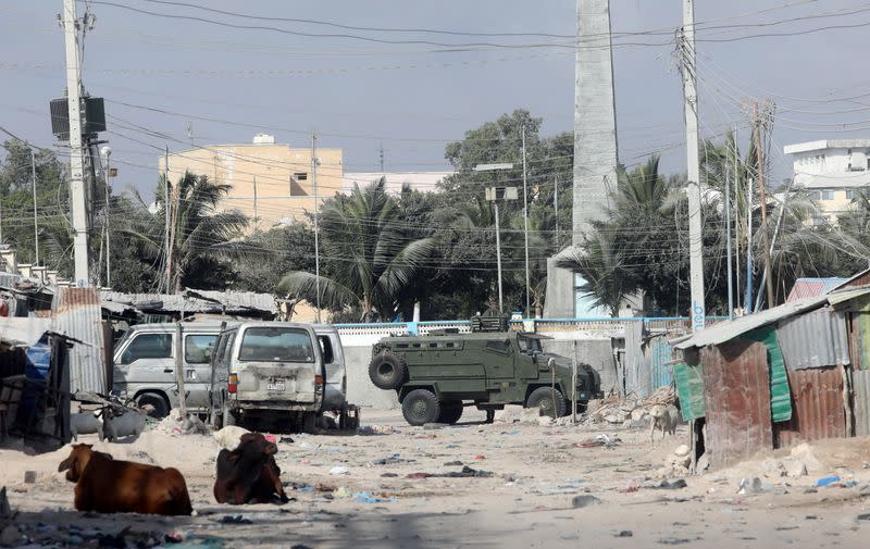 An armoured personnel carrier (APC) drives on a sealed off street to prevent a protest over delayed elections in Mogadishu