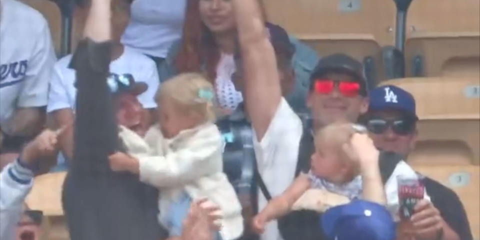 A dad with a baby strapped to his chest caught a foul ball at the a Dodgers game. (LA Dodgers/Twitter)