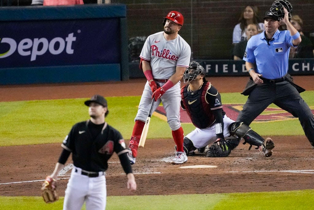 Philadelphia Phillies' Kyle Schwarber hits a home run off Arizona Diamondbacks relief pitcher Kyle Nelson during the fourth inning in Game 4 of the baseball NL Championship Series in Phoenix, Friday, Oct. 20, 2023.(AP Photo/Rick Scuteri)