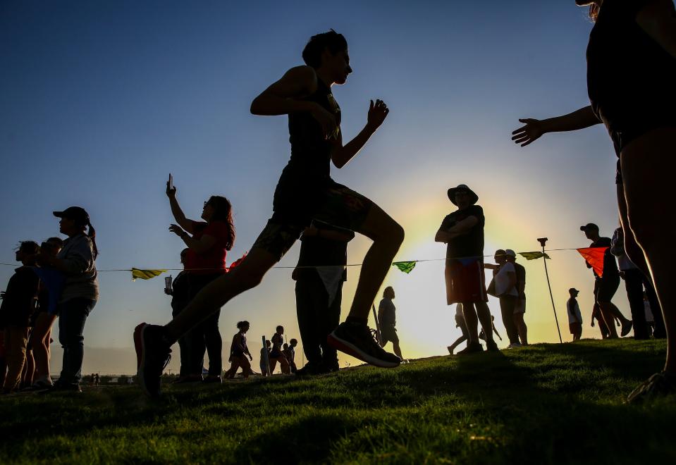 Runners cross the finish line of the boys' race of the first DEL cross country meet of the year at Xavier College Preparatory High School in Palm Desert, Calif., Wednesday, Sept. 20, 2023.