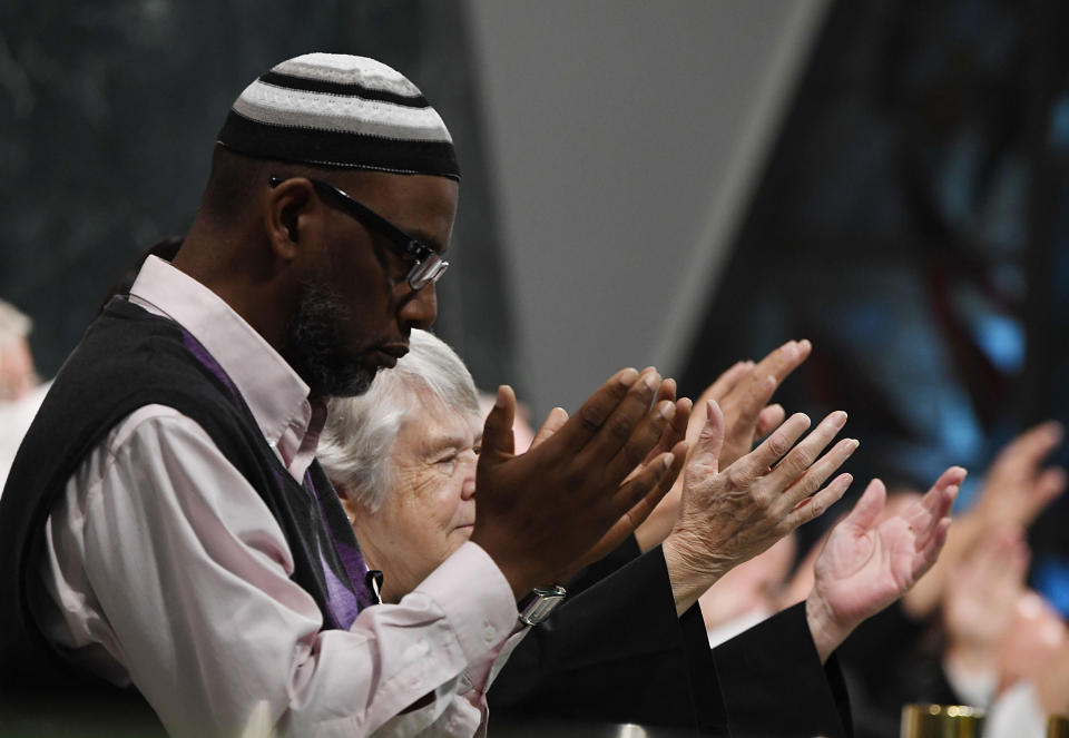 People pray together during a vigil at Guardian Angel Cathedral.&nbsp;