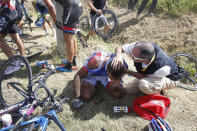 FDJ rider William Bonnet of France receives medical help as he sits on the ground after a fall July 6, 2015. REUTERS/Eric Gaillard