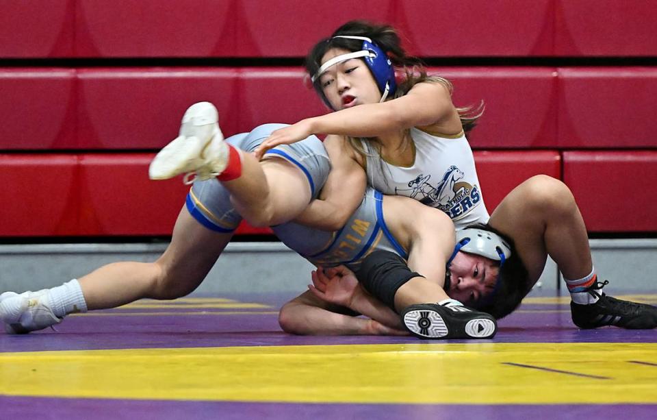 Central Catholic 106-pound wrestler Jillian Wells puts a Wood High School wrestler in a hold during the D IV Sac-Joaquin Section team wrestling duals at Lincoln High School in Stockton, Calif., Saturday, Jan. 27, 2024.