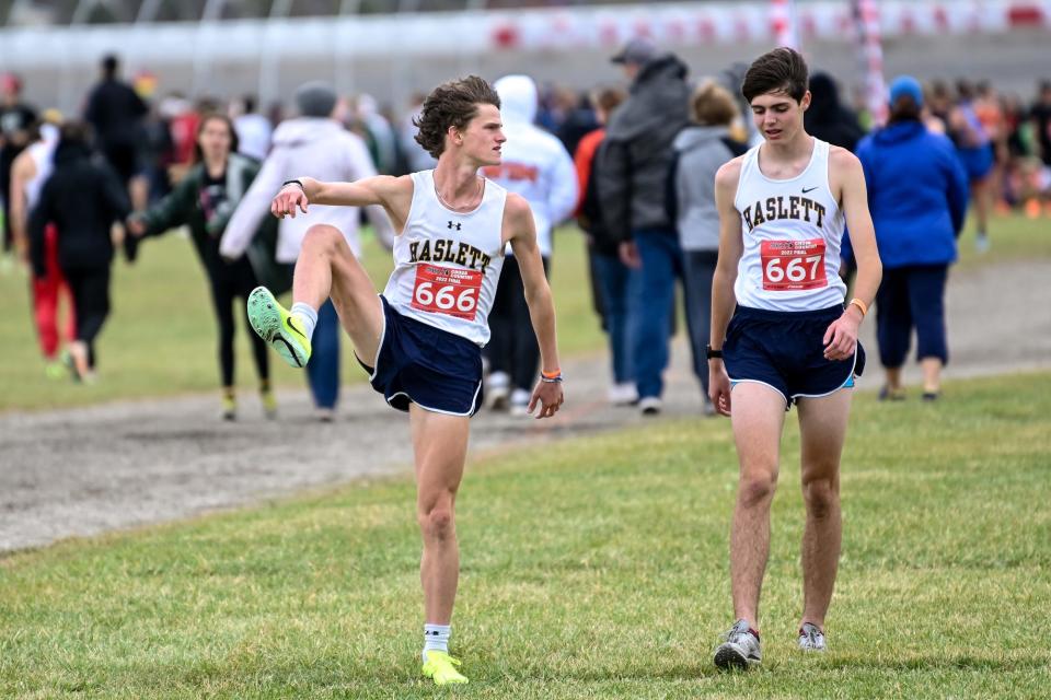 Haslett's Nate Carmody, left, and Dylan Lydic warm up before the Division 2 boys state cross country final on Saturday, Nov. 5, 2022, at Michigan International Speedway in Brooklyn.